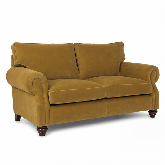 A classic two-seater loveseat sofa upholstered in a textured mustard yellow velvet fabric, featuring rolled arms, dark brown turned wood legs, and a clean studio background.