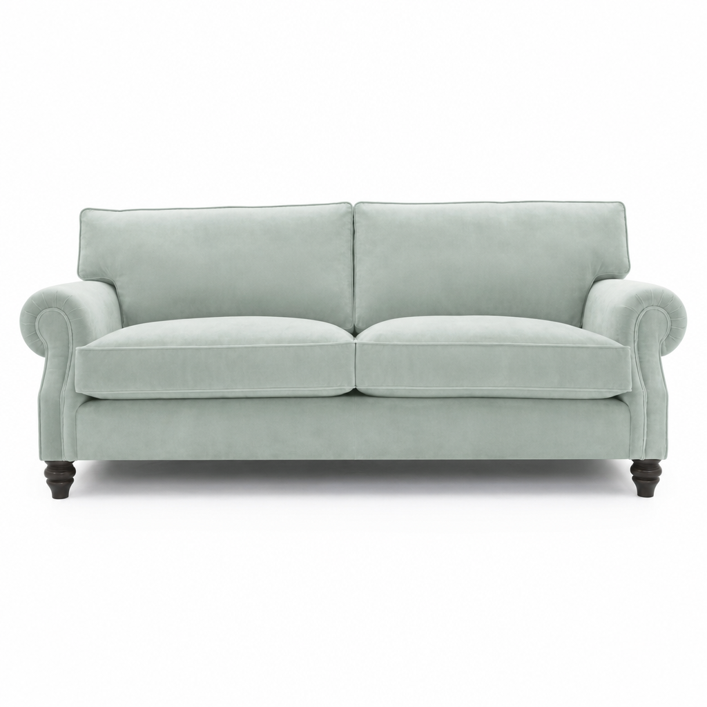 A two-seater loveseat sofa upholstered in a light sage green fabric, featuring dark turned wooden legs, shown against a plain white background.