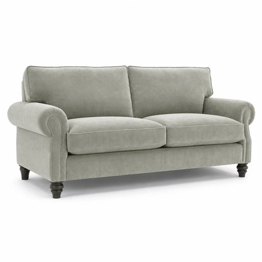 A light sage green upholstered loveseat with rolled arms, two back cushions, two seat cushions, and dark turned wooden legs, shown on a plain white background.