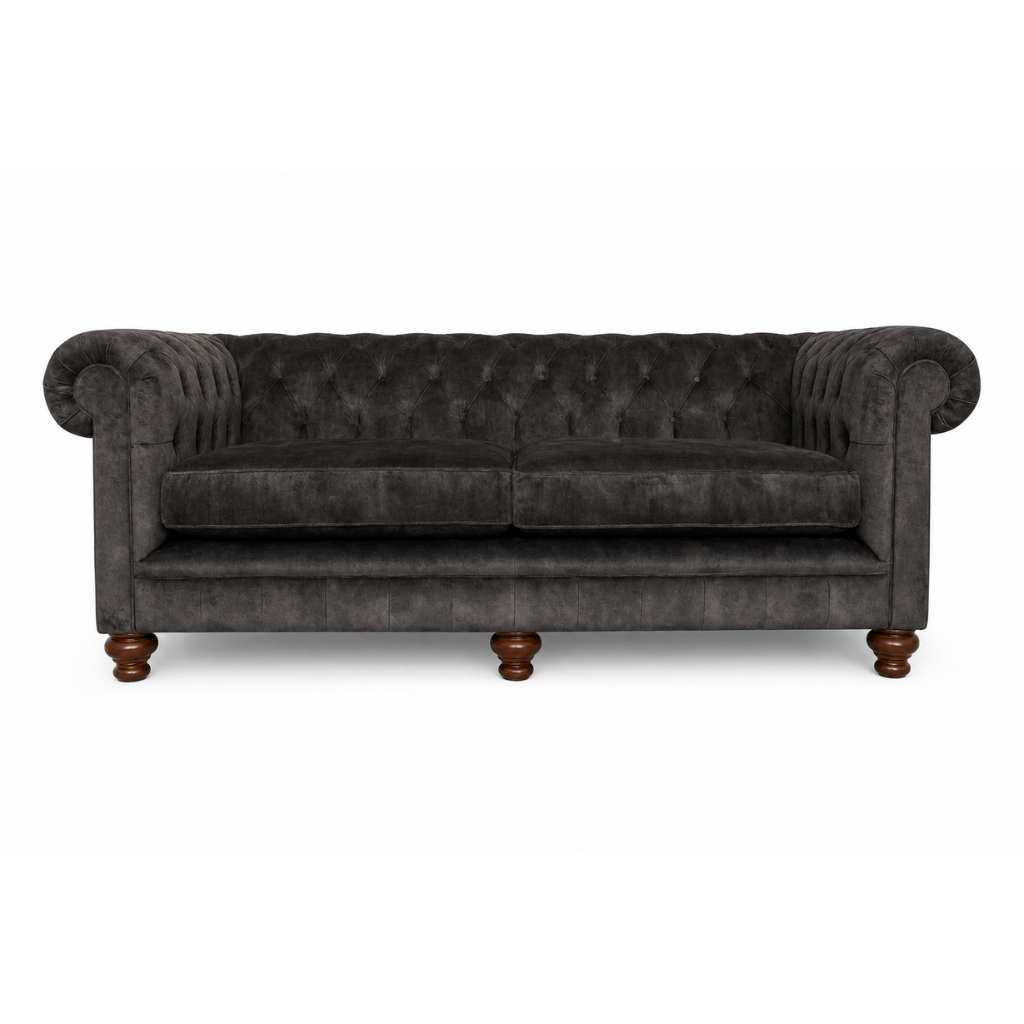 Dark gray tufted sofa with wooden legs on a white background