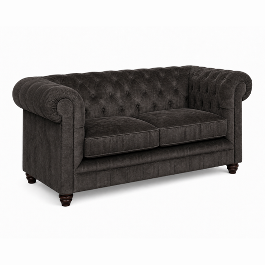 Dark gray tufted sofa on a white background