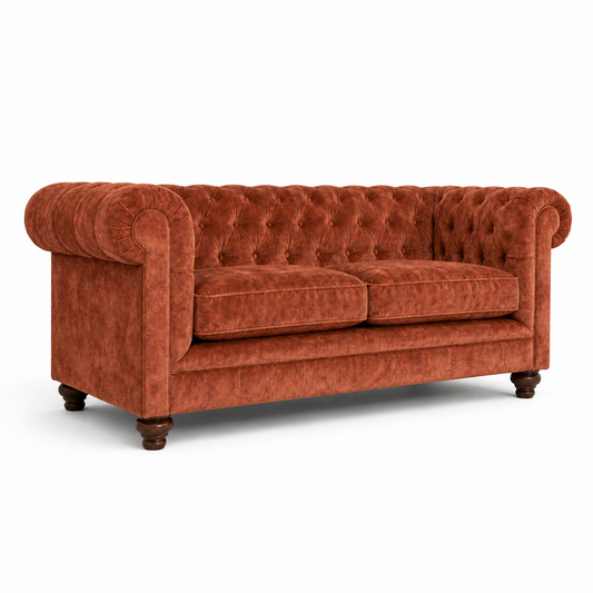 Orange velvet sofa on a white background