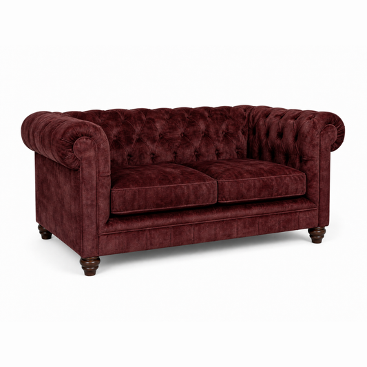 Maroon velvet sofa on a white background