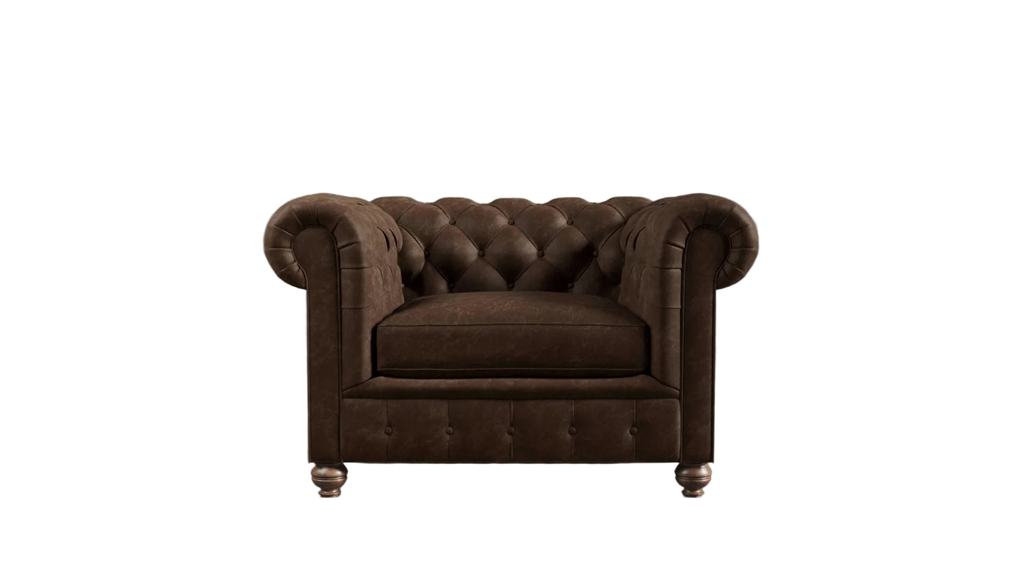 Brown leather chesterfield sofa against a textured wall.