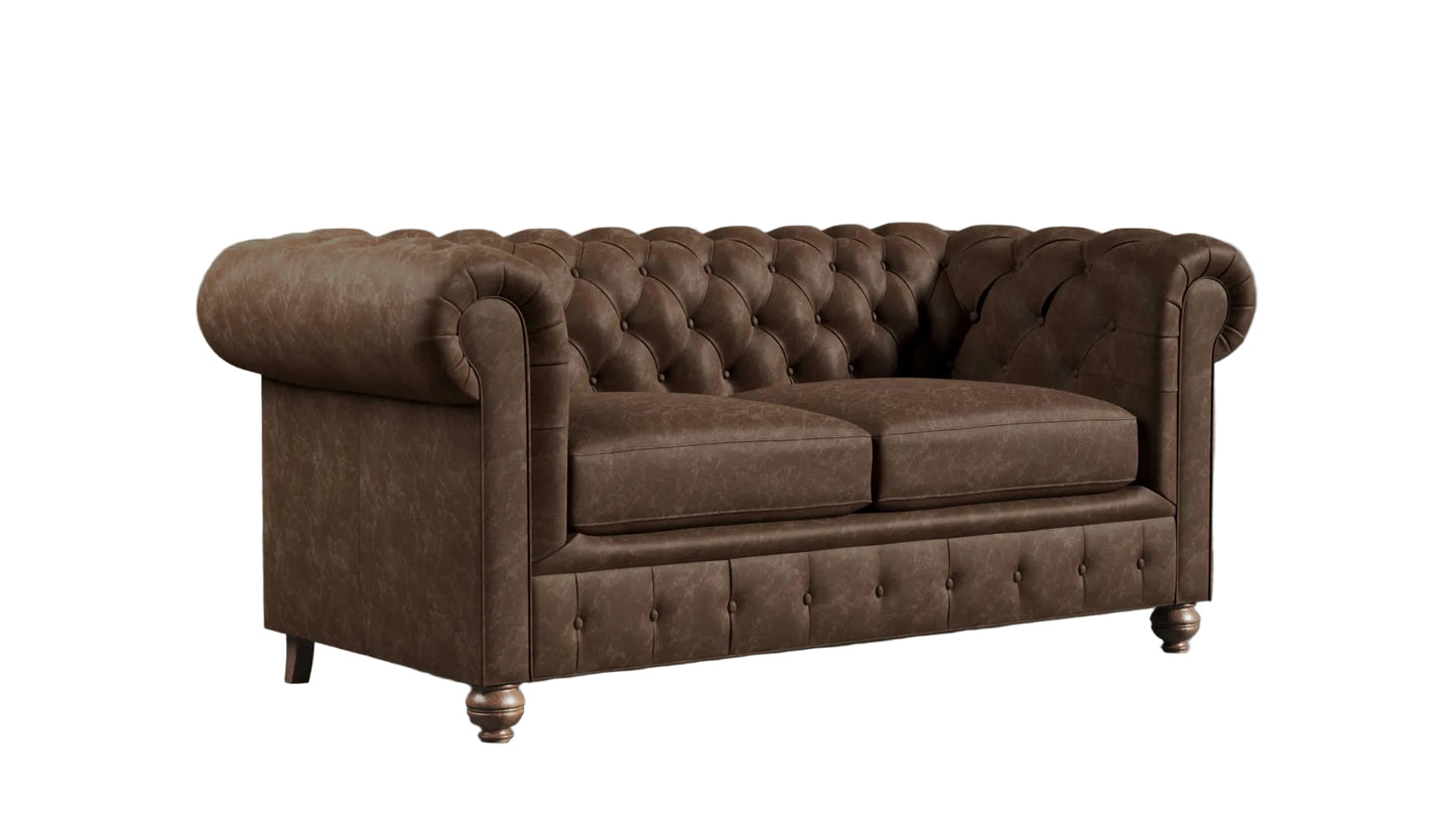 Brown leather chesterfield sofa against a textured wall.