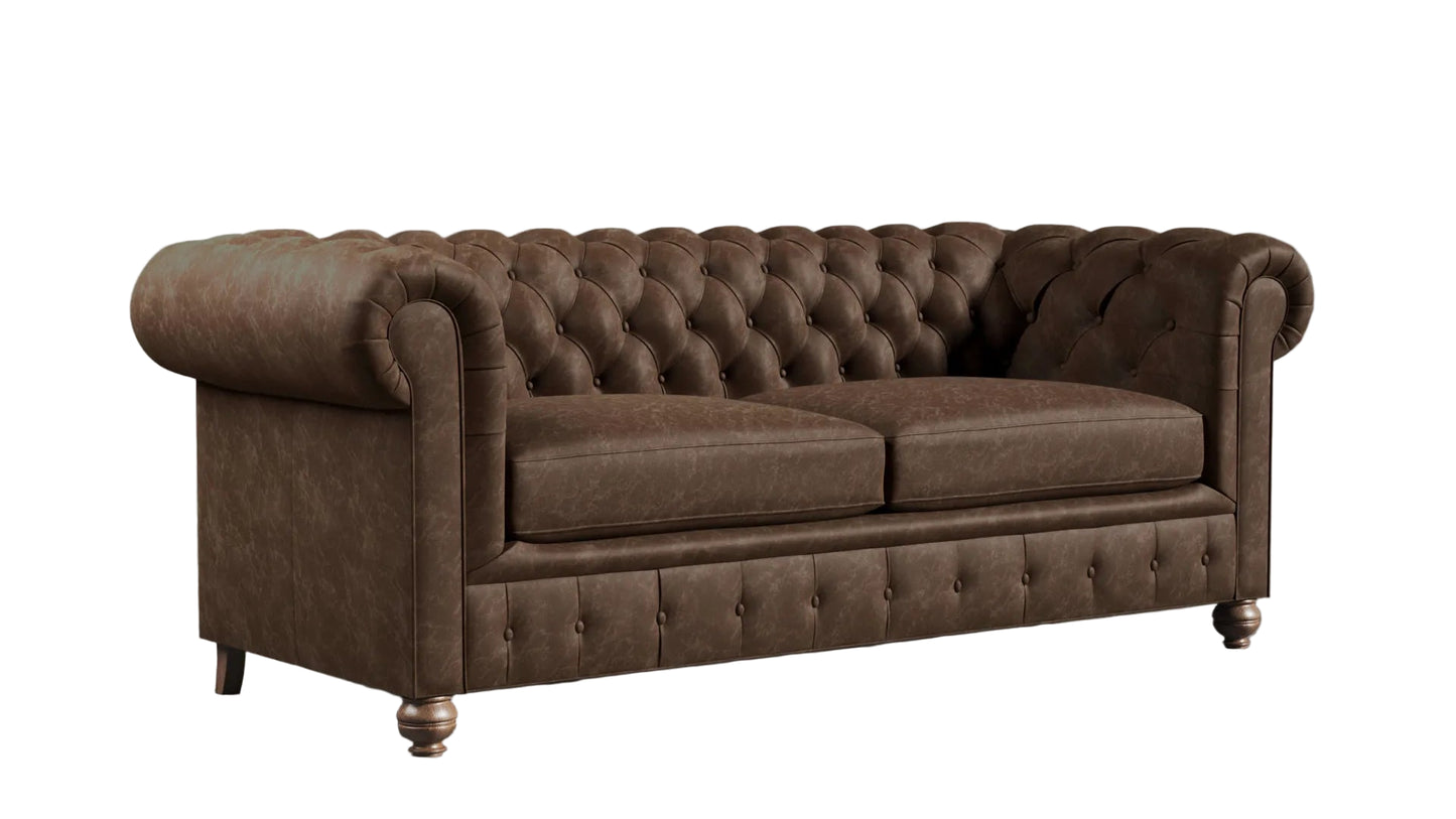 Brown leather chesterfield sofa against a textured wall.