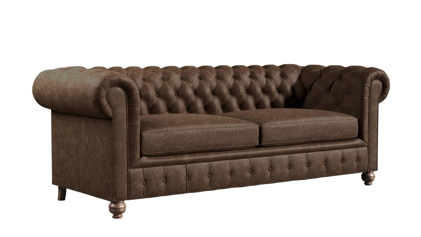 Brown leather chesterfield sofa against a textured wall.