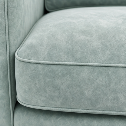 Close-up of a light gray velvet sofa cushion with a soft texture.