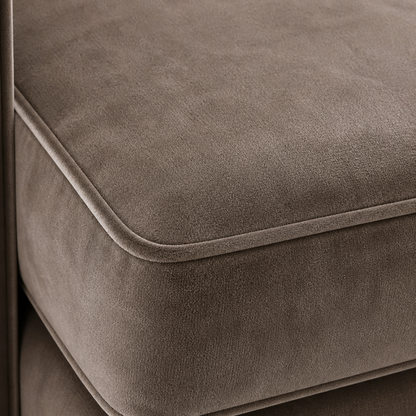 Close-up of a grey velvet upholstered sofa seat with visible stitching