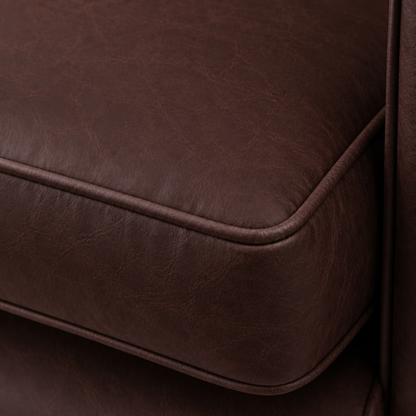 Close-up of a brown leather ottoman corner