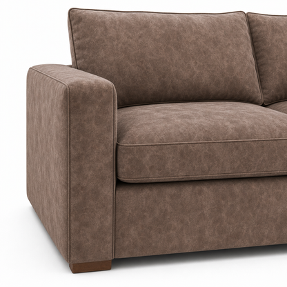 A close-up of a brown upholstered loveseat or sofa section with a textured fabric, showing the armrest, back cushion, seat cushion, and lower skirt on a white background.