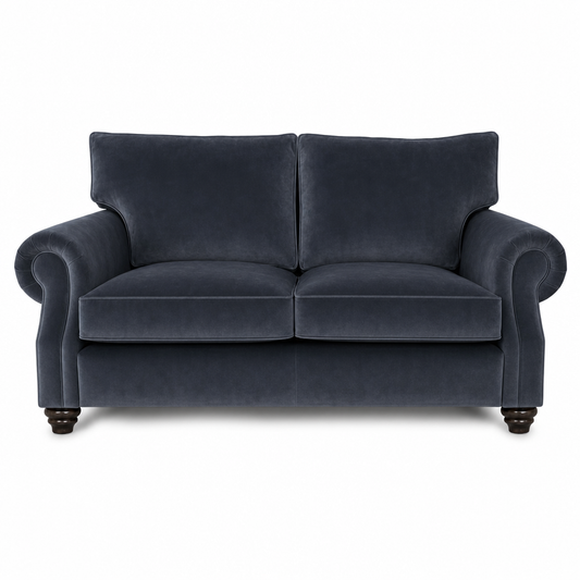 A classic two-seater loveseat sofa upholstered in dark navy blue velvet fabric, featuring rolled arms, two back cushions, and dark wooden turned legs, shown against a plain white background.