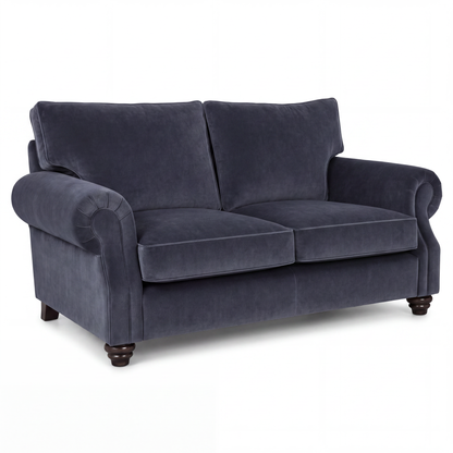 A navy blue velvet loveseat sofa with rolled arms, two back cushions, two seat cushions, and dark wooden turned legs, shown on a plain white background.