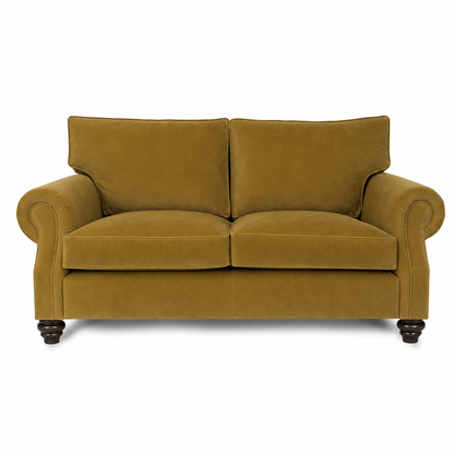 A classic two-seater loveseat sofa upholstered in a textured mustard yellow velvet fabric, featuring rolled arms, dark wooden turned legs, and a clean white background.