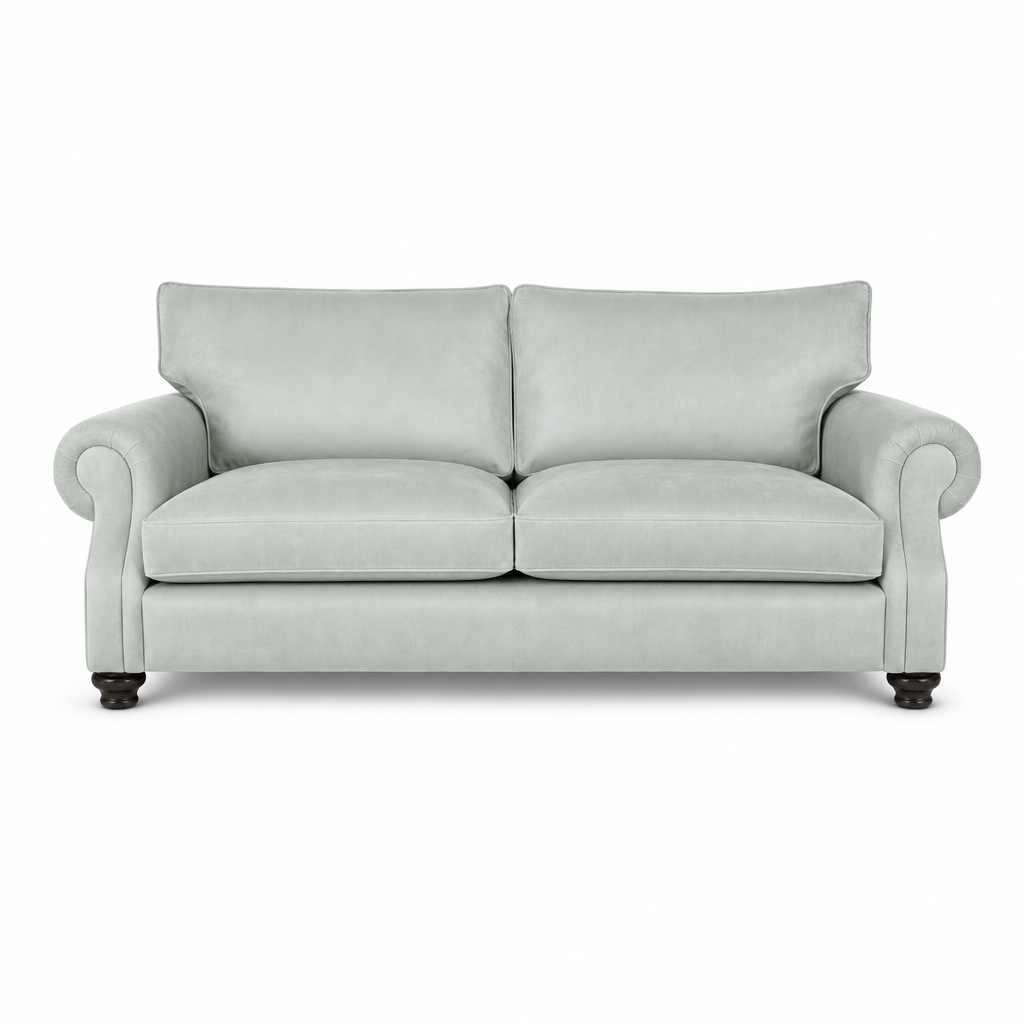 A light sage green upholstered loveseat with rolled arms, two back cushions, two seat cushions, and dark wooden legs, shown against a plain white background.