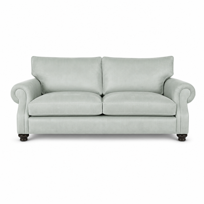 A light sage green upholstered loveseat with rolled arms, two back cushions, two seat cushions, and dark wooden legs, shown against a plain white background.