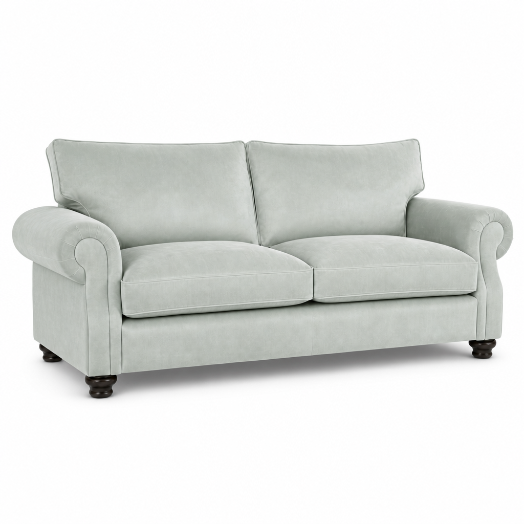 A light sage green upholstered loveseat with rolled arms, two back cushions, two seat cushions, and dark wooden feet, shown on a plain white background.