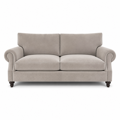 A classic two-seater loveseat sofa upholstered in a textured light beige fabric, featuring rolled arms, dark wooden turned legs, and a clean silhouette on a white background.