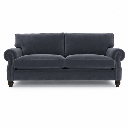 A classic two-seater loveseat sofa upholstered in dark slate blue velvet fabric, featuring dark wooden turned legs, shown against a plain white background.