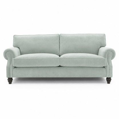 A two-seater loveseat sofa upholstered in a light sage green fabric, featuring dark turned wooden legs, shown against a plain white background.