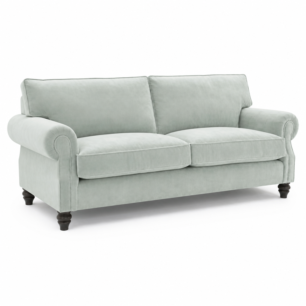A classic two-seater loveseat sofa upholstered in a light sage green fabric, featuring rolled arms, dark turned wooden legs, and a clean silhouette on a white background.