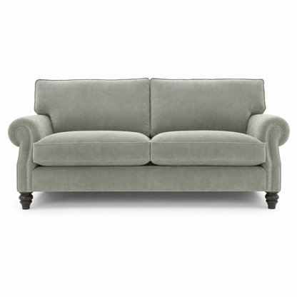 A classic two-seater loveseat sofa upholstered in a textured light sage green fabric, featuring dark turned wooden legs and rolled arms, shown against a plain white background.