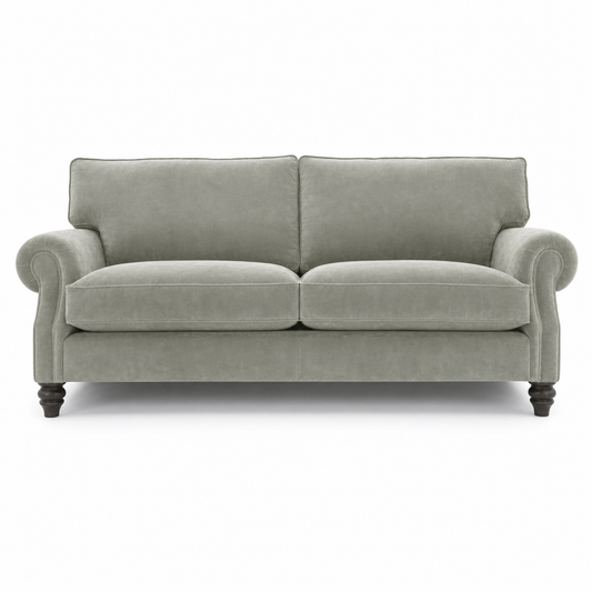 A classic two-seater loveseat sofa upholstered in a textured light sage green fabric, featuring dark turned wooden legs and rolled arms, shown against a plain white background.