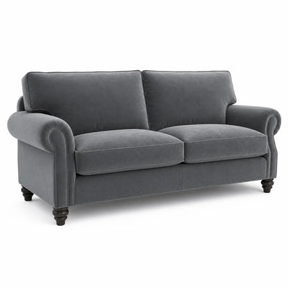 A dark gray velvet loveseat sofa with rolled arms, two back cushions, two seat cushions, and dark turned wooden legs, shown on a plain white background.