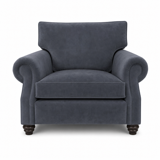 A classic armchair upholstered in dark slate blue velvet fabric, featuring rolled arms, a high backrest, and dark wooden turned legs, shown against a plain white background.