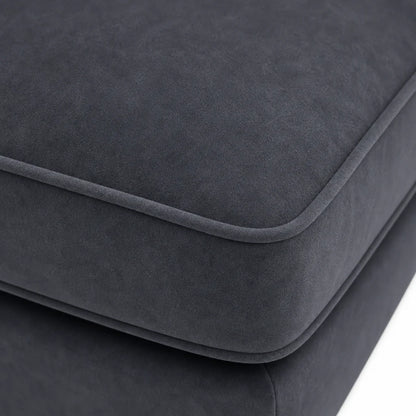 Close-up of a dark charcoal gray upholstered cushion with rounded edges and a soft suede-like texture, shown against a white background.