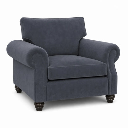 A classic armchair upholstered in textured navy blue fabric, featuring rolled arms, a high backrest, and dark turned wooden legs, shown against a plain white background.
