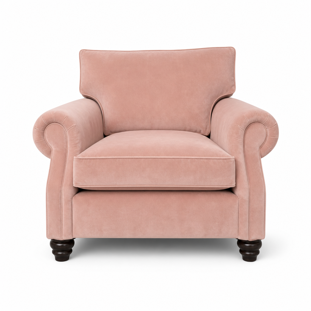 A classic pink velvet armchair with rolled arms, a high backrest, and dark wooden turned legs, shown against a plain white background.
