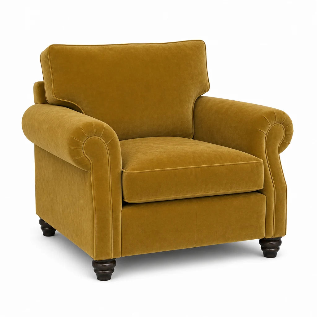A classic armchair upholstered in a rich mustard yellow velvet fabric, featuring rolled arms, a high backrest, and dark turned wood legs, shown against a plain white background.