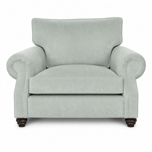 A classic upholstered armchair in a light sage green fabric, featuring rolled arms, a high backrest, and dark wooden feet, shown against a plain white background.