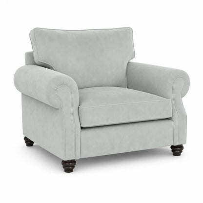 A light sage green upholstered armchair with rolled arms, a high back cushion, and dark wooden turned legs, shown on a plain white background.
