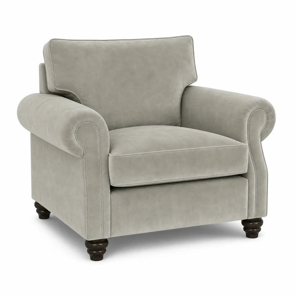 A classic upholstered armchair in a light gray fabric with dark brown turned wooden legs, shown against a plain white background.