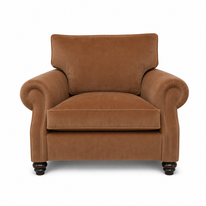 A classic brown velvet armchair with rolled arms, a high backrest, and dark wooden turned legs, shown against a plain white background.