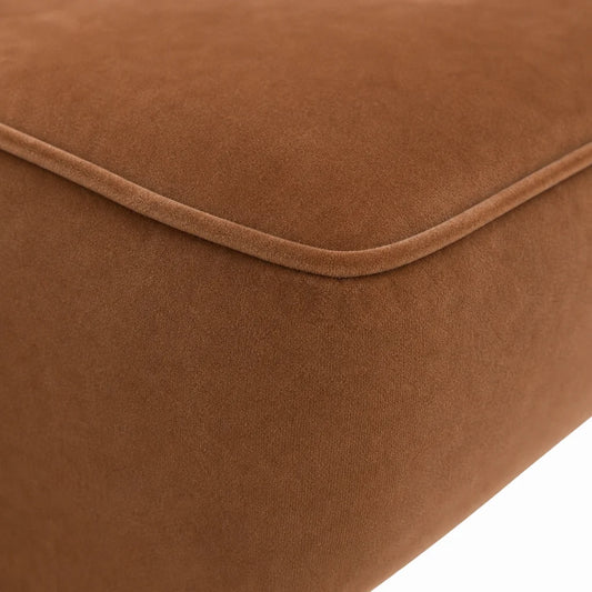 Close-up of a brown suede or microfiber upholstered cushion corner with a stitched seam, shown against a white background.