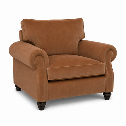 A classic brown velvet armchair with rolled arms, a high backrest, and dark turned wooden legs, shown on a plain white background.