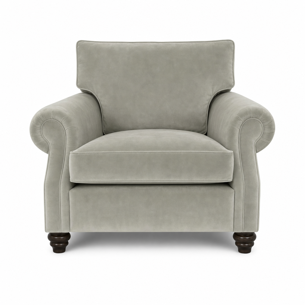 A classic upholstered armchair in a light gray fabric, featuring rolled arms, a high backrest, and dark turned wooden legs, shown against a plain white background.