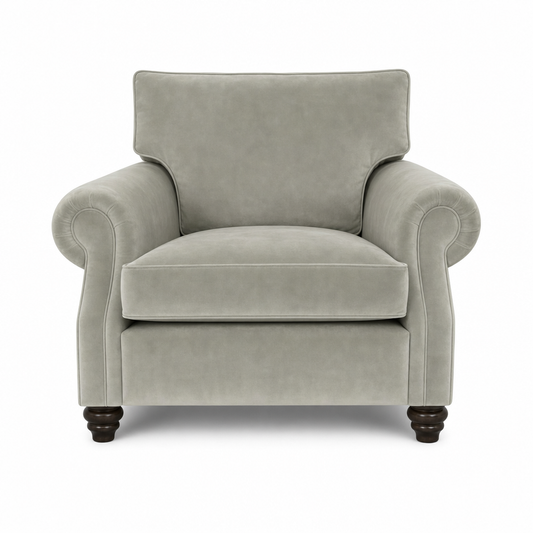 A classic upholstered armchair in a light gray fabric, featuring rolled arms, a high backrest, and dark turned wooden legs, shown against a plain white background.