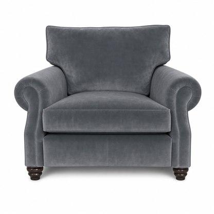 A classic gray velvet armchair with rolled arms, a high backrest, and dark wooden turned legs, shown against a plain white background.