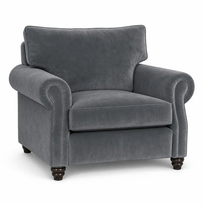 A classic gray velvet armchair with rolled arms, a high back cushion, and dark wooden turned legs, shown against a plain white background.