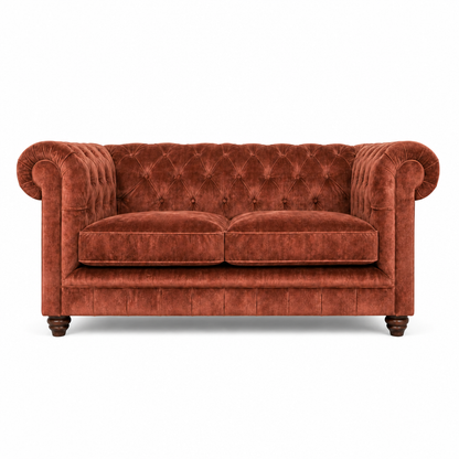 Red velvet sofa with tufted backrest on a white background