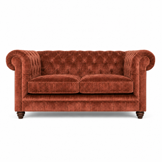 Red velvet sofa with tufted backrest on a white background