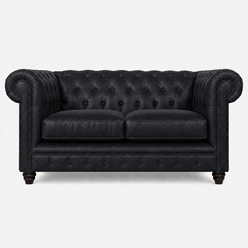 Black leather sofa with tufted backrest on a white background