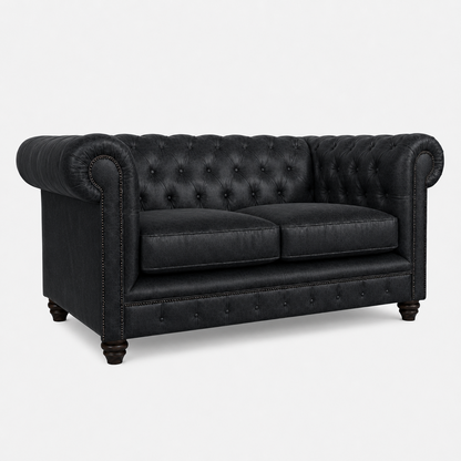 Black leather sofa with tufted backrest on a white background