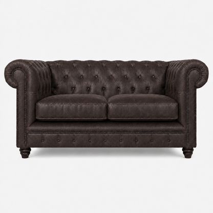 Dark brown leather sofa with tufted backrest on a white background