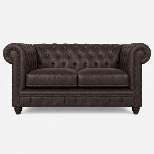 Dark brown leather sofa with tufted backrest on a white background