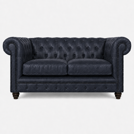 Blue velvet sofa with tufted backrest on a white background